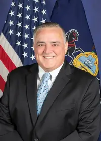 Man in suit with American flag background