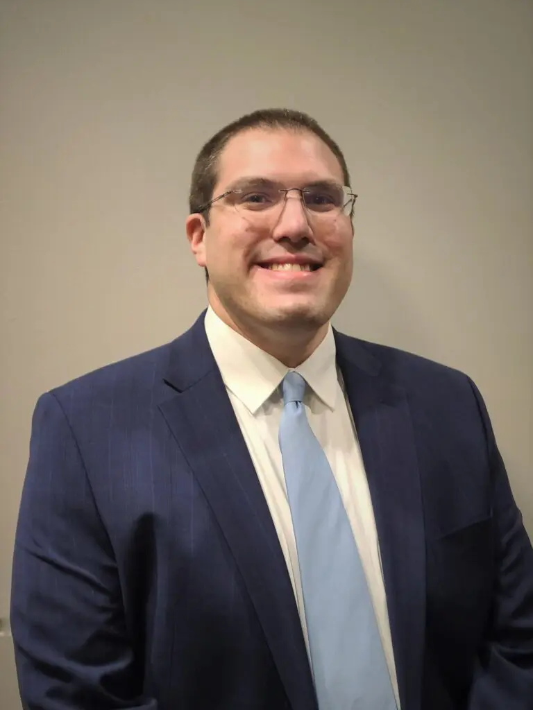 Man in blue suit smiling