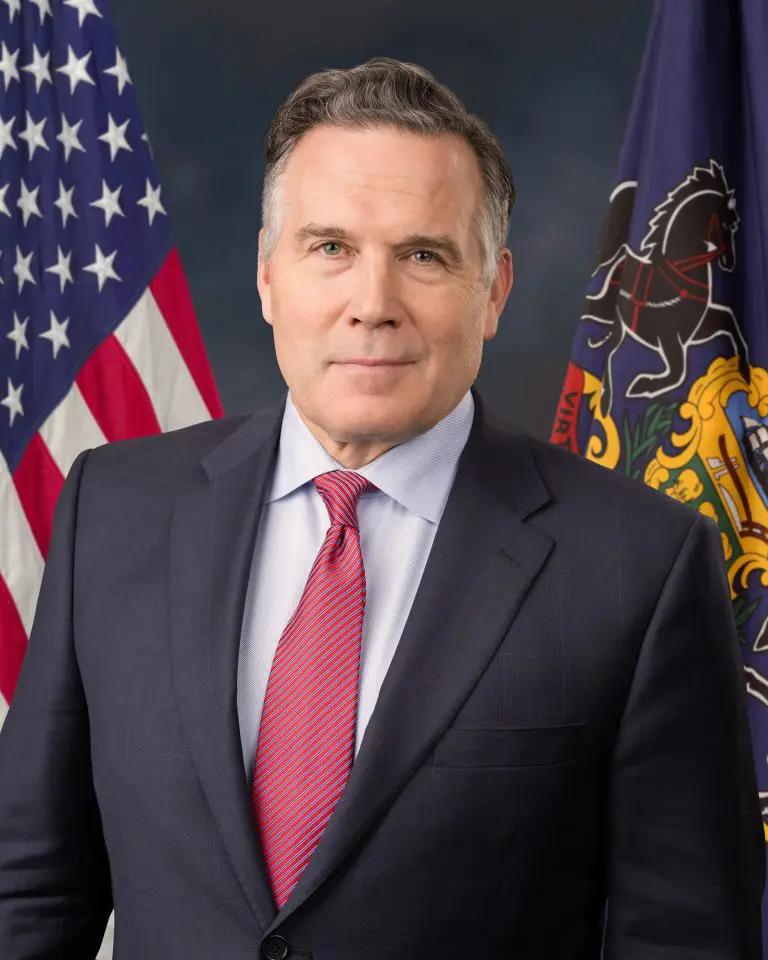 Professional portrait with state flag backdrop