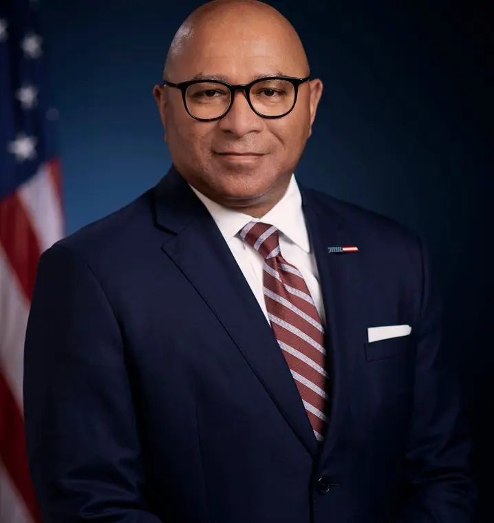 Man in suit with American flag background
